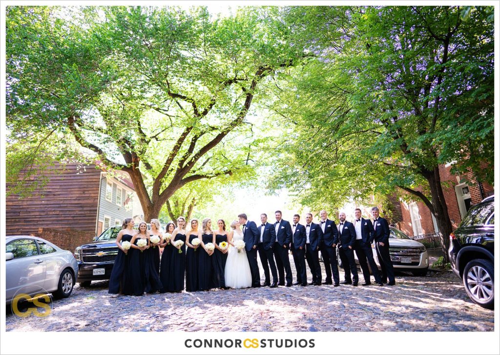 wedding portraits with bride and groom and wedding party on sunny day in old town Alexandria, Virginia photography by Connor Studios 