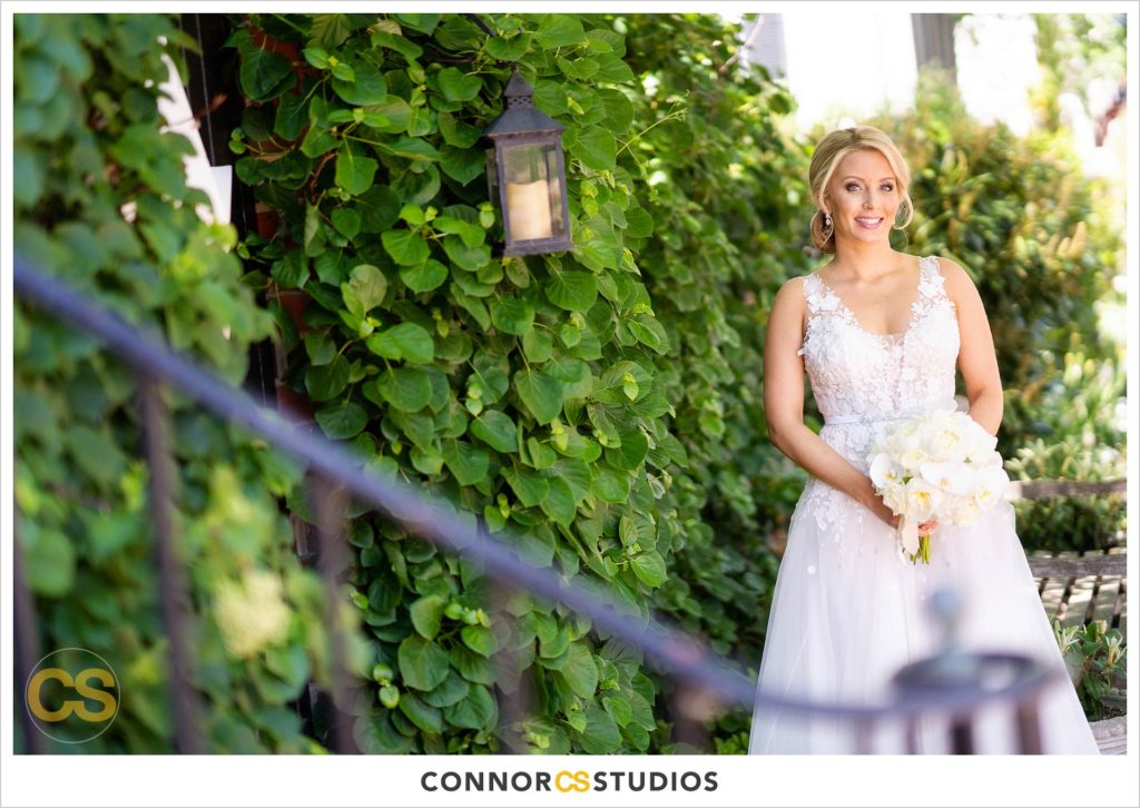 wedding portraits with bride near ivy wall on sunny day in old town Alexandria, Virginia photography by Connor Studios 