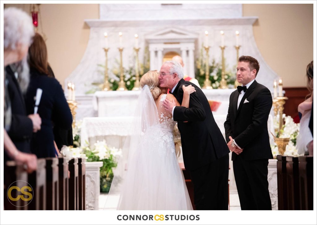 smiling bride and dad walking down the aisle at The Basilica of St. Mary Church in old town Alexandria, Virginia photography by Connor Studios 