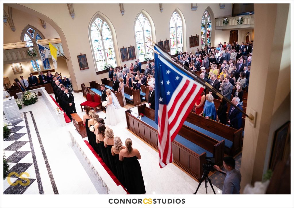 wedding with patriotic american flag and bride and groom at The Basilica of St. Mary Church in old town Alexandria, Virginia photography by Connor Studios 