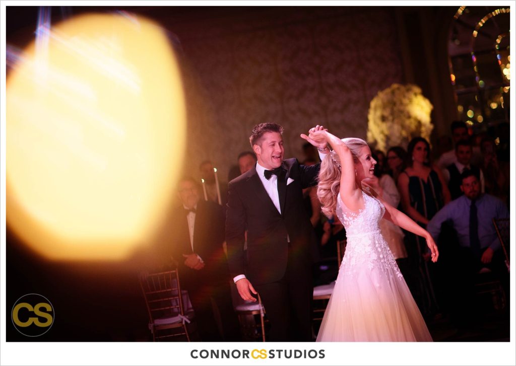 first dance during luxury wedding with candles and gold colors in the ballroom at Fairmont Hotel in Washington, DC photography by Connor Studios 