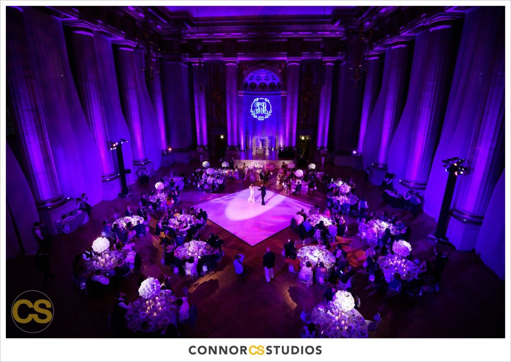 first dance at wedding with purple lighting at the Andrew W. Mellon Auditorium in Washington, DC by Connor Studios