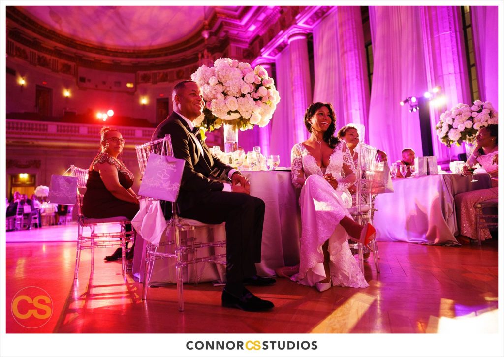 speeches at wedding with purple and pink lighting at the Andrew W. Mellon Auditorium in Washington, DC by Connor Studios