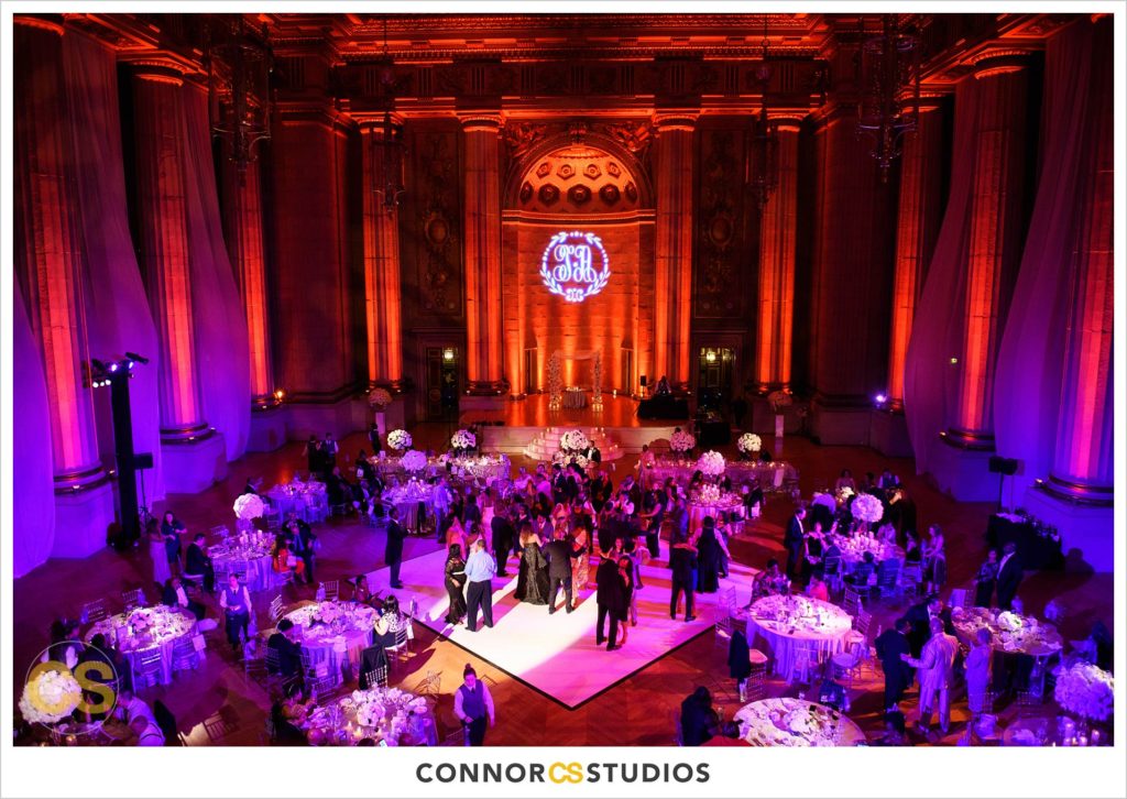 dancing at wedding reception with purple and pink lighting at the Andrew W. Mellon Auditorium in Washington, DC by Connor Studios