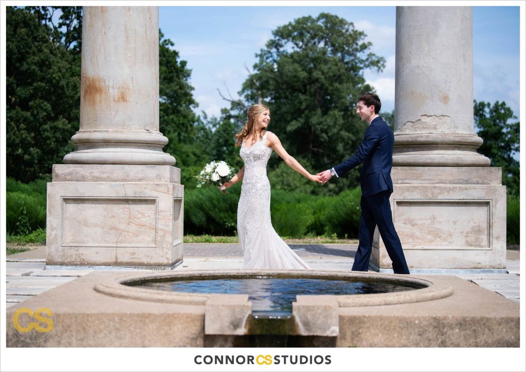 photograph of bride and groom on their wedding day for portraits at the National Capitol Columns at the national arboretum in washington, dc by connor studios