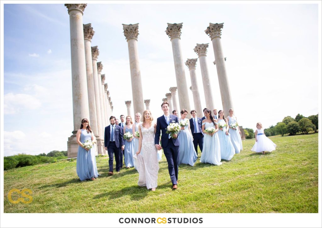photograph of bride and groom with their wedding party on their wedding day for portraits at the National Capitol Columns at the national arboretum in washington, dc by connor studios