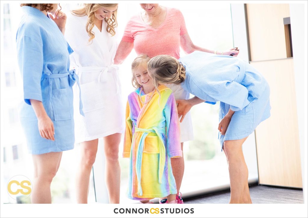 bride, bridesmaids in cute blue robes and flower girl in multicolor robe playing at the conrad washington dc hotel by connor studios