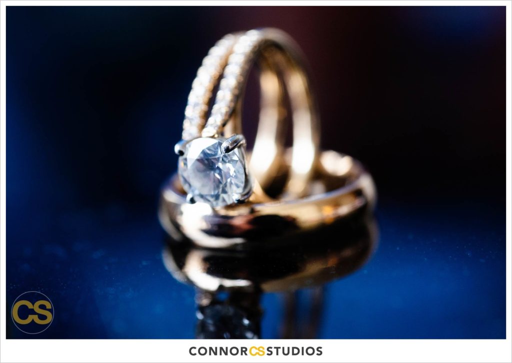 detail photograph of wedding rings on blue table at the conrad washington dc hotel by connor studios