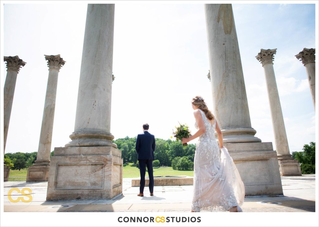 photograph of bride and groom’s first look on their wedding day at the National Capitol Columns at the national arboretum in washington, dc by connor studios