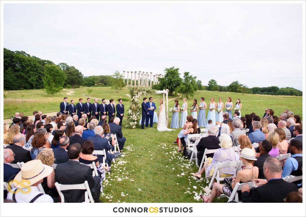 outdoor summer wedding ceremony with the National Capitol Columns at the national arboretum in washington, dc by connor studios