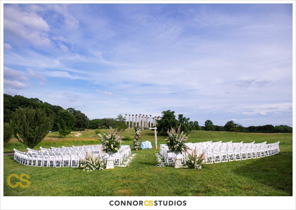 outdoor summer wedding ceremony with the National Capitol Columns at the national arboretum in washington, dc by connor studios