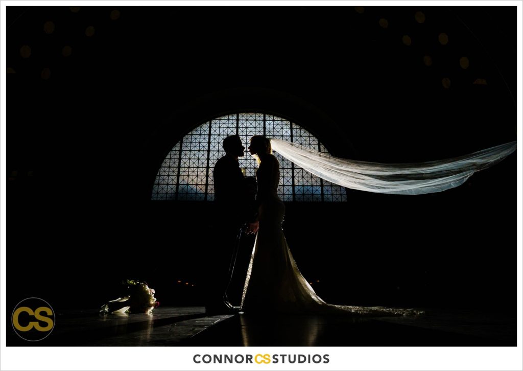 silhouette of bride and groom in dramatic portrait at union station in washington, dc by connor studios