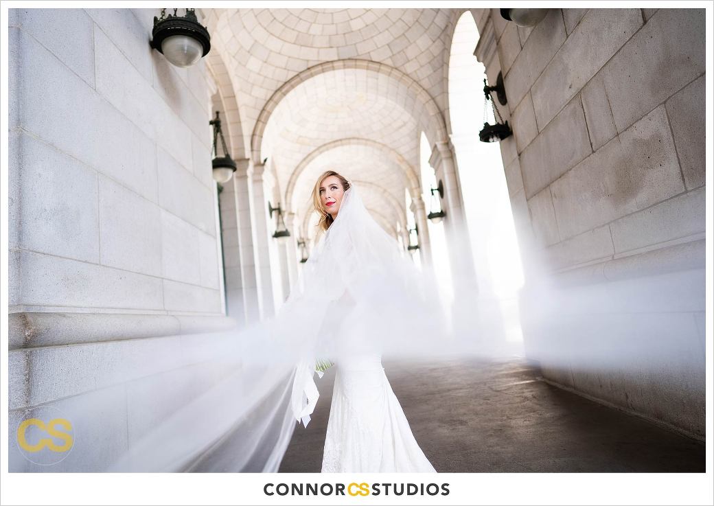 stunning bride with flowing veil portrait at union station in washington, dc by connor studios