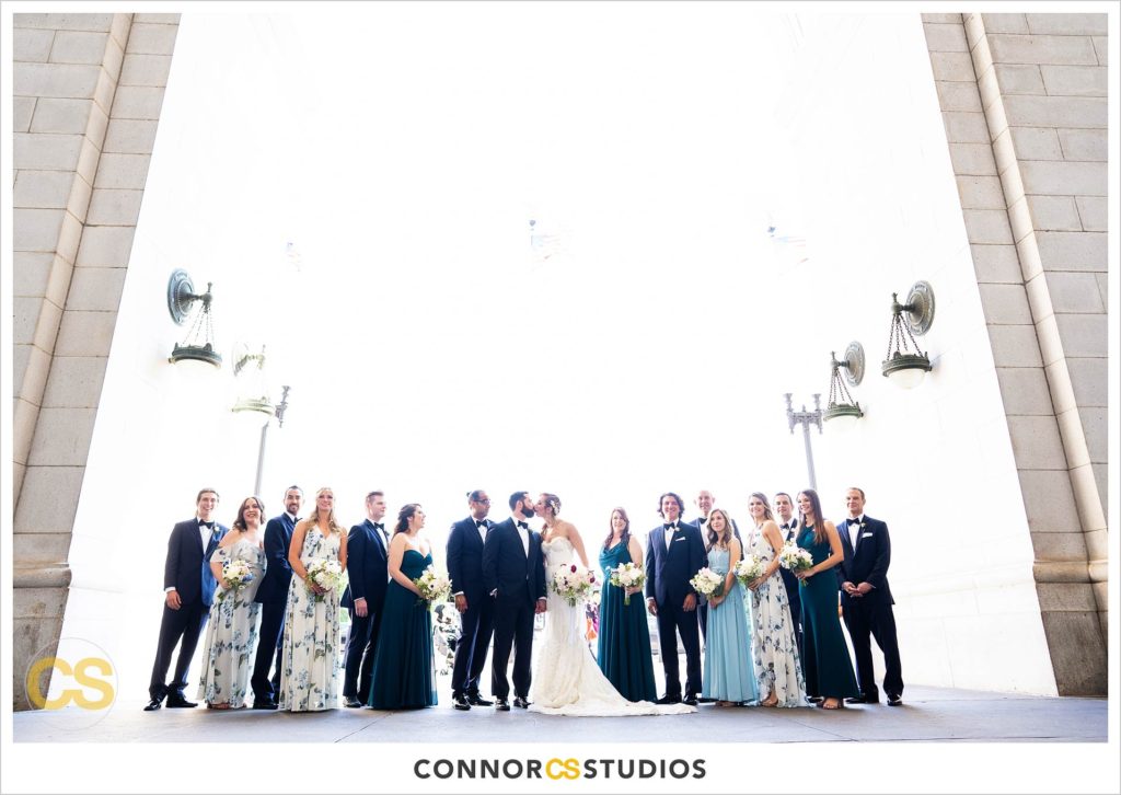 bride and groom and wedding party with green and white mismatched dresses portraits at union station in washington, dc by connor studios