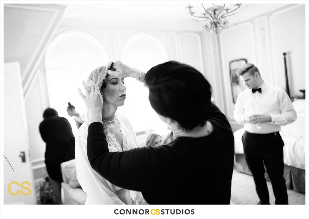 bride getting ready with makeup artist at the Cosmos Club in Washington, DC by Connor Studios
