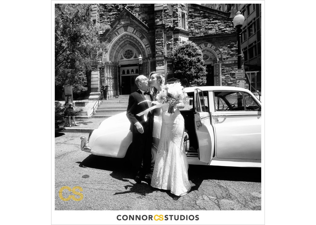 bride kissing father in front of a vintage rolls royce at her wedding at st. patrick's catholic church in washington, dc by connor studios