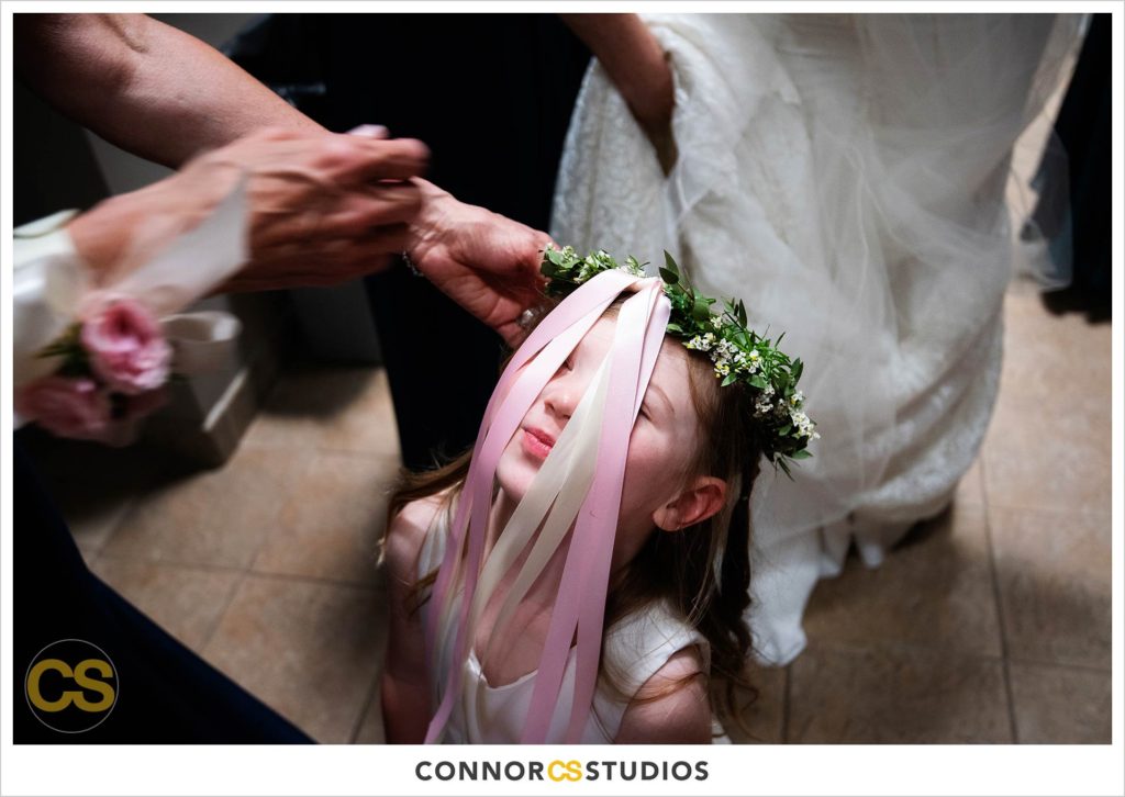 flower girl getting crown of flowers before wedding at st. patrick's catholic church in washington, dc by connor studios