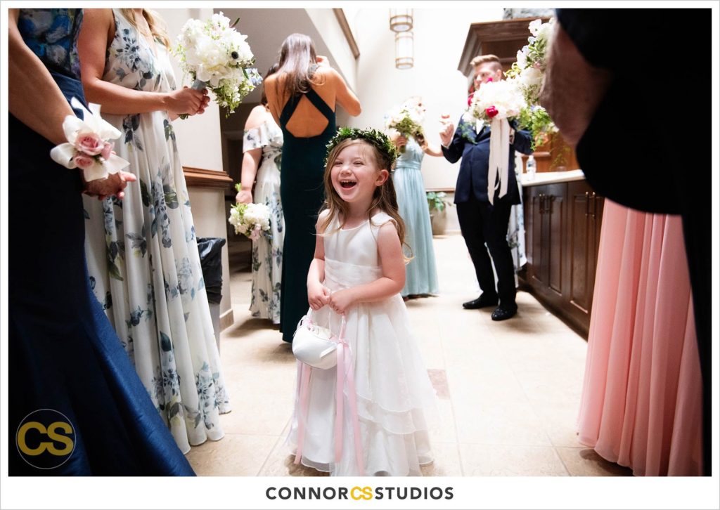 flower girl laughing before wedding at st. patrick's catholic church in washington, dc by connor studios