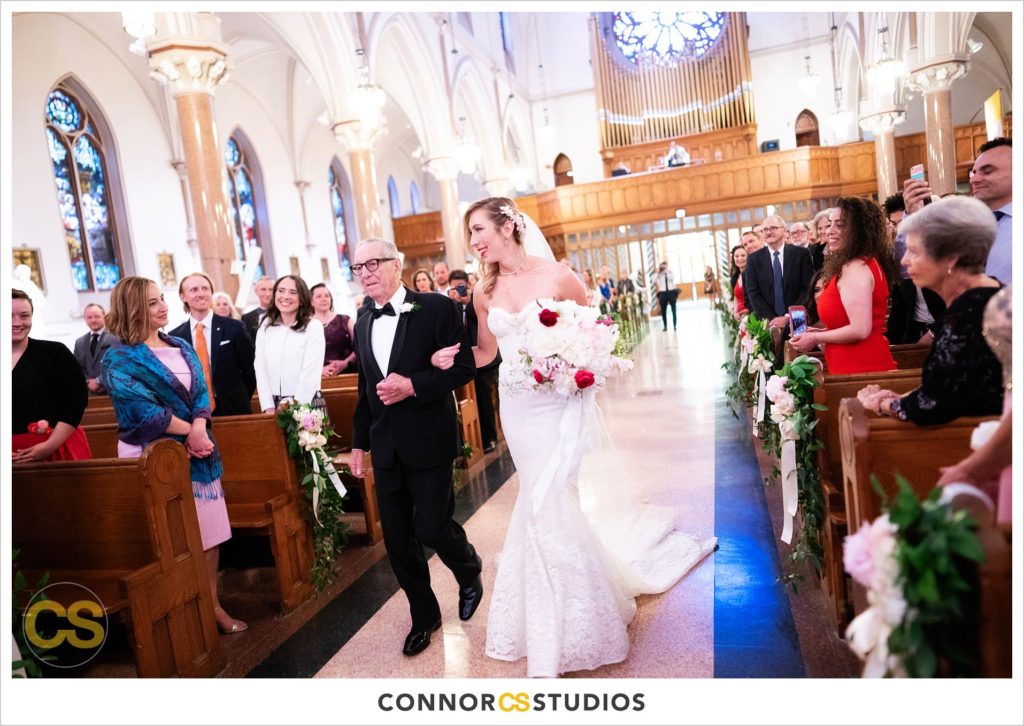 bride and father walking down the aisle at her wedding at st. patrick's catholic church in washington, dc by connor studios