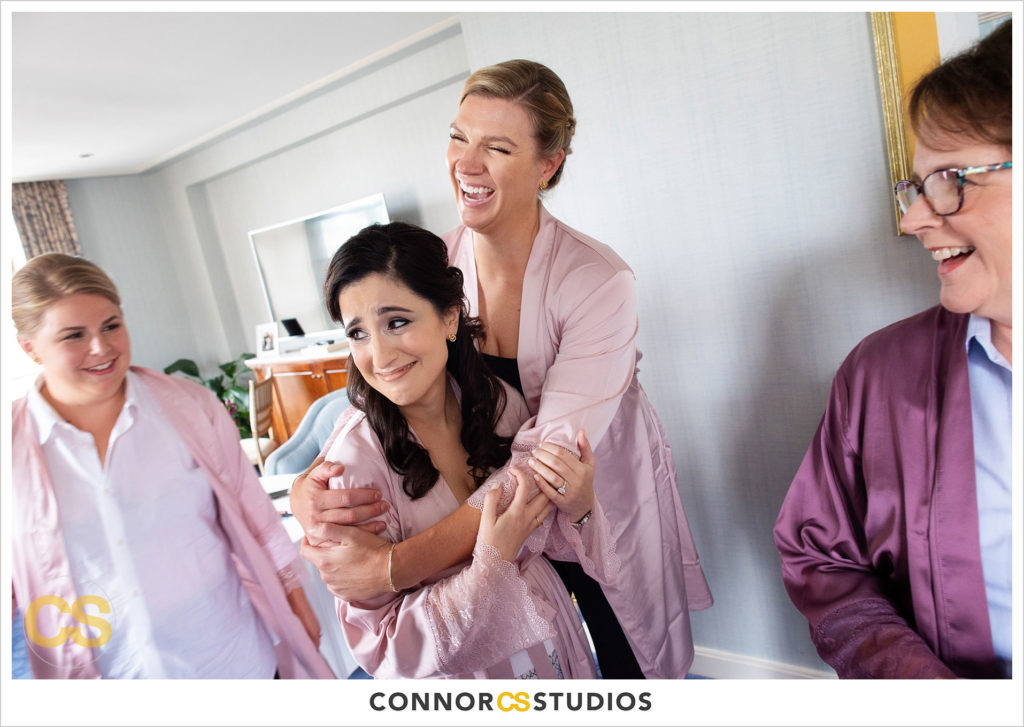 bridesmaids getting ready in pink and purple robes at the st regis hotel in washington, dc by connor studios