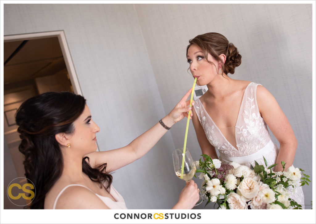 bride and bridesmaid funny moment getting ready at the st regis hotel in washington, dc by connor studios