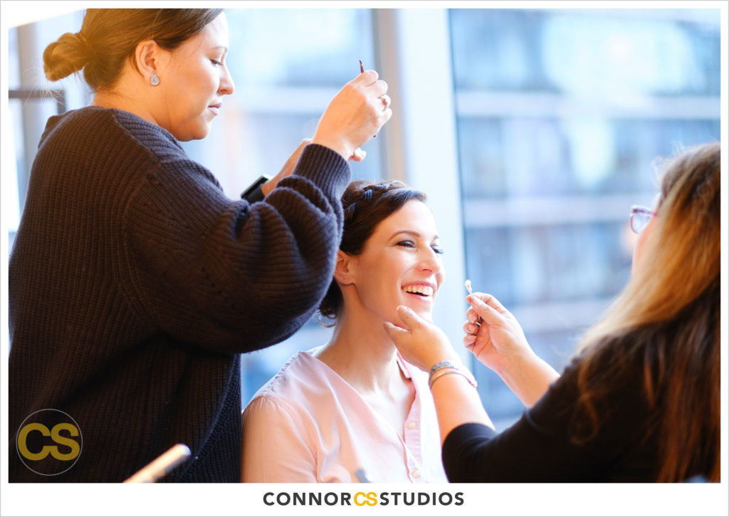 bride getting hair and makeup done by carola myers at conrad dc hotel in washington, dc by connor studios