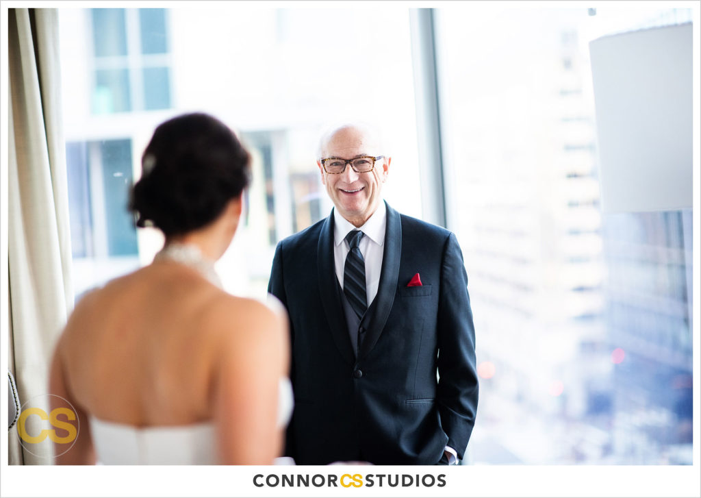 bride seeing dad after getting in wedding dress at conrad dc hotel in washington, dc by connor studios