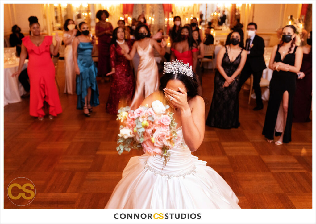 bouquet toss at luxury wedding at the cosmos club during covid-19 in washington, dc by connor studios